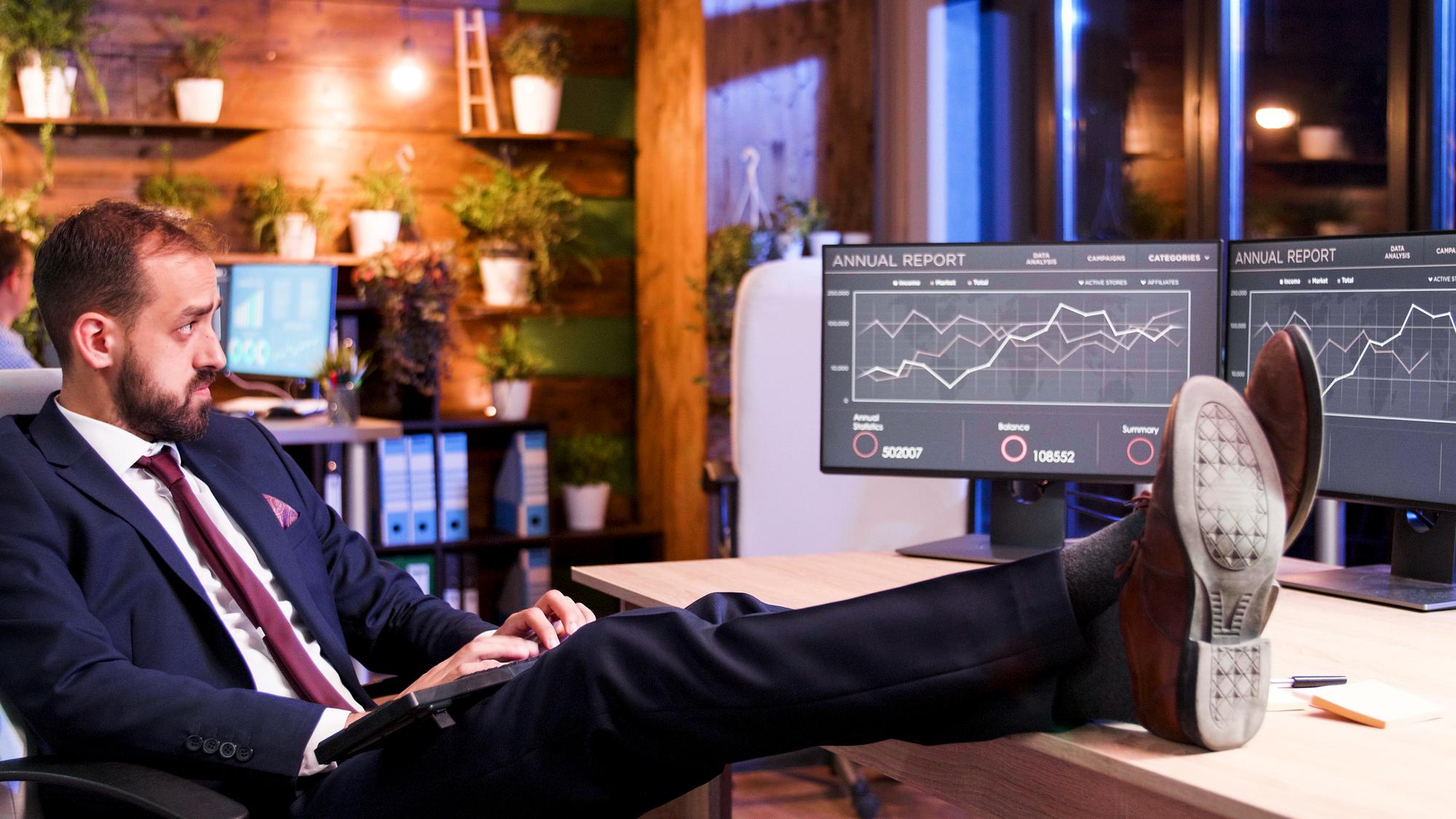 Analyst at screen with candlestick charts